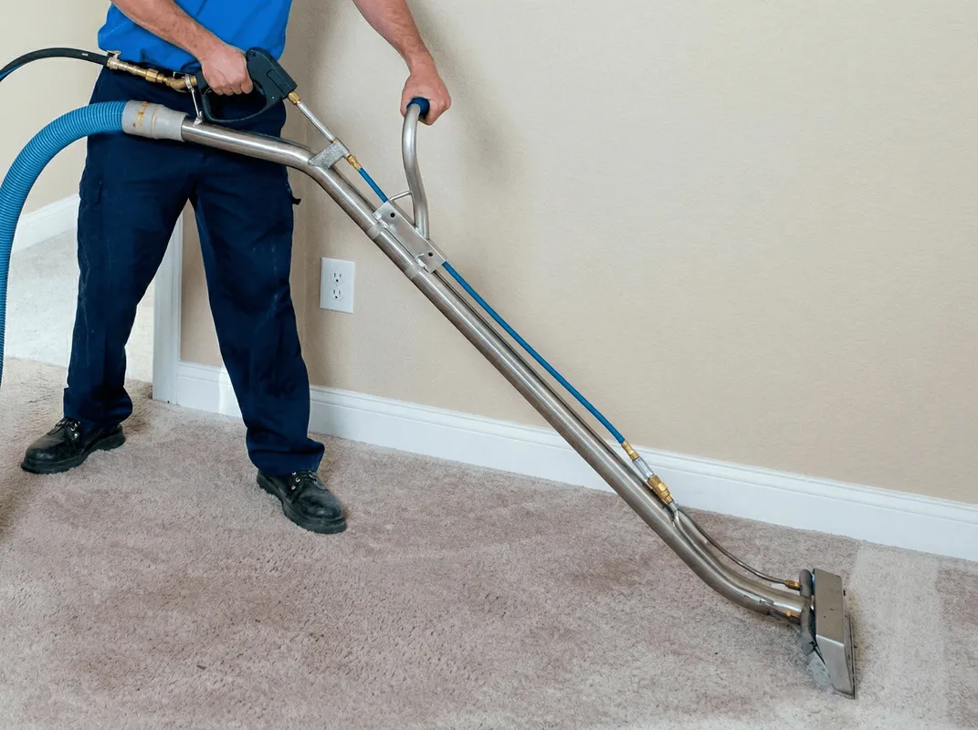 Professional operating a liquid removal machine on a carpeted floor in Green Bay, WI